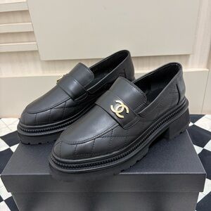 CHANEL Black Quilted Loafers with Gold Accent
